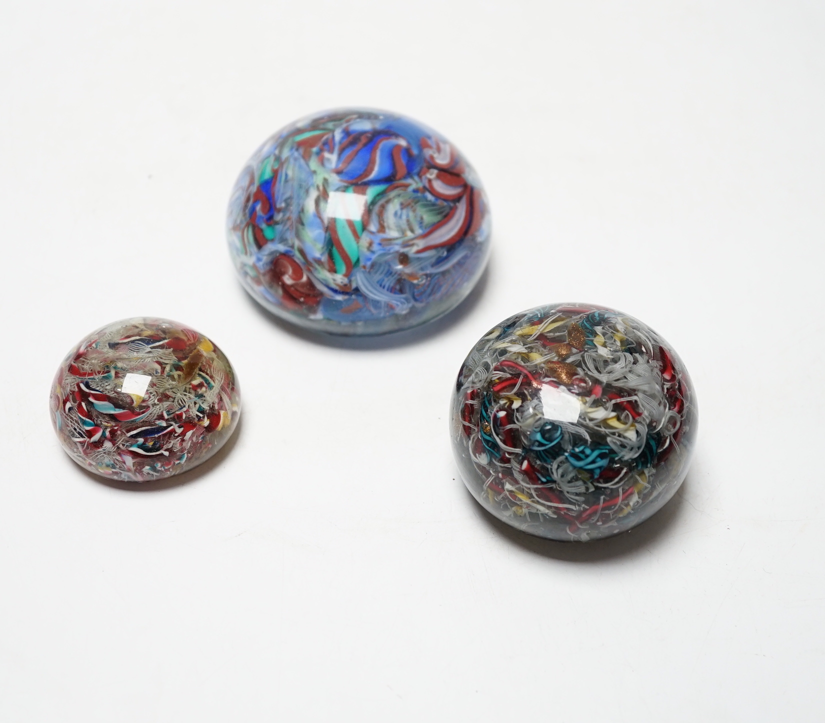 Three 19th century Venetian scrambled glass paperweights, largest 8.5cm